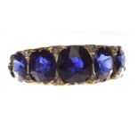 IMPRESSIVE VICTORIAN SAPPHIRE FIVE STONE RING with a boat shaped bezel set with graduated cushion