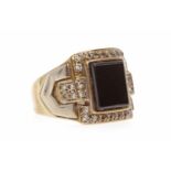 GENTLEMAN'S NINE CARAT GOLD GEM SET SIGNET RING set with a central black rectangular stone within a