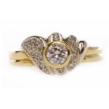 EIGHTEEN CARAT GOLD DIAMOND DRESS RING the ornate fan bezel with a principal collet set round