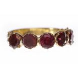 EARLY NINETEENTH CENTURY GARNET DRESS RING set with five foil backed garnets, each 4mm diameter,