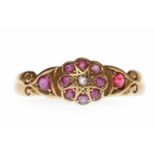 VICTORIAN EIGHTEEN CARAT GOLD RUBY AND DIAMOND DRESS RING with a central floral motif set with