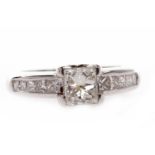 EIGHTEEN CARAT GOLD DIAMOND SET BAND the princess cut stone of approximately 0.