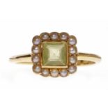 EDWARDIAN PASTE AND PEARL DRESS RING set with a central square green paste surrounded by split