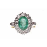 EIGHTEEN CARAT GOLD EMERALD AN DIAMOND CLUSTER RING the central oval emerald 9.7x6.