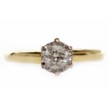 EIGHTEEN CARAT GOLD DIAMOND SOLITAIRE RING with an illusion set round brilliant cut diamond of