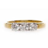 EIGHTEEN CARAT GOLD DIAMOND THREE STONE RING set with a central stone of approximately 0.