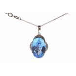 NINE CARAT WHITE GOLD TOPAZ PENDANT set with a large oval blue topaz 18mm long and in a diamond