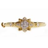 GEM SET BANGLE the central gem set flower section flanked by two square gems, with foreign marks,