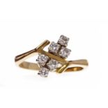 EIGHTEEN CARAT GOLD DIAMOND DRESS RING set with two groups of three round brilliant cut diamonds to