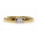 EIGHTEEN CARAT GOLD DIAMOND SOLITAIRE RING with a tension set princess cut diamond of approximately