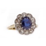EIGHTEEN CARAT GOLD SAPPHIRE AND DIAMOND CLUSTER RING set with a central oval sapphire 7.6x5.8x3.