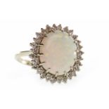 EIGHTEEN CARAT WHITE GOLD OPAL AND DIAMOND CLUSTER RING set with a central oval cabochon cut opal