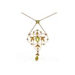 FINE EDWARDIAN GEM SET NECKLET openwork, of sinuous form, set with two oval peridots,