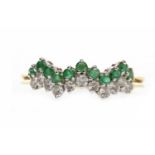 EIGHTEEN CARAT GOLD EMERALD AND DIAMOND RING set with an undulating row of emeralds and another of