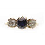 EIGHTEEN CARAT GOLD SAPPHIRE AND DIAMOND THREE STONE RING set with a central oval sapphire 6mm long