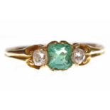 VICTORIAN EMERALD AND DIAMOND THREE STONE RING set with a central emerald cut emerald 5x4mm and