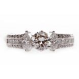 IMPRESSIVE DIAMOND DRESS RING the central round brilliant cut diamond of approximately 0.