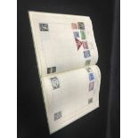FOUR STAMP ALBUMS along with a group of loose stamps