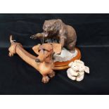 FIVE PIGGIN' FIGURES along with a ceramic figure of a bear on a plinth,