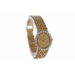 LADY'S BAUME & MERCIER EIGHTEEN CARAT GOLD DIAMOND SET QUARTZ COCKTAIL WATCH the oval gold coloured