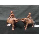 TWO CHINESE CARVED WOODEN FIGURES ON BUFFALO
