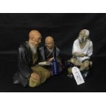 CERAMIC FIGURE OF SEATED JAPANESE MAN along with a ceramic figure of two men reading (2)