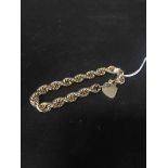 NINE CARAT GOLD ROPETWIST BRACELET with heart shaped padlock clasp and safety chain,16.