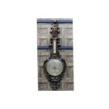 LARGE 19TH CENTURY OAK BAROMETER OF BAVARIAN DESIGN the pediment carved with the face of a