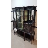 VICTORIAN EBONISED DISPLAY CABINET OF ROCOCO DESIGN the serpentine moulded cornice with central