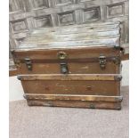 EARLY 20TH CENTURY LEATHER AND BRASS BOUND CABIN TRUNK with lock plate and clasps, stud decorations,