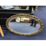 OVAL WALL MIRROR IN A GILT GESSO FRAME