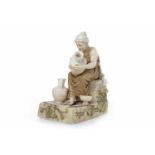 ROYAL DUX FIGURE OF A FEMALE POTTER in classical dress, seated decorating a pot,