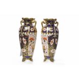 PAIR OF ROYAL CROWN DERBY 'IMARI' PATTERN TWIN HANDLED VASES of tapering circular form,