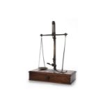 SET OF CHEMISTS' PAN SCALES BY W & T AVERY fixed on an oblong, mahogany base,