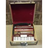 MID-20TH CENTURY ITALIAN FRONTALINI ACCORDION with red, marble effect finish, in case,