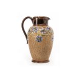 ROYAL DOULTON LAMBETH STONEWARE JUG the baluster body decorated with applied flowers on a textured