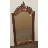 FRENCH UPRIGHT BEVELLED WALL MIRROR WITH ARCHED CENTRE contained in a moulded walnut frame with