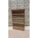 MAHOGANY FOUR SECTION STACKING BOOKCASE by Globe Wernicke, with outset base section, 87 cm wide,