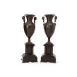 PAIR OF FRENCH BRONZE AND SLATE GARNITURE VASES in the form of classical double handled urns,