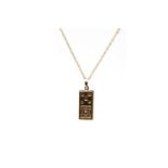 A NINE CARAT GOLD INGOT PENDANT ON CHAIN