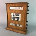 A 1950s WOODEN FRAMED ROLLER CALENDAR