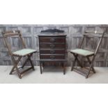 AN EDWARDIAN MUSIC CABINET WITH A PAIR OF FOLDING CHAIRS