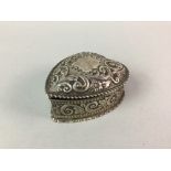 A SILVER EMBOSSED HEART SHAPED TRINKET BOX