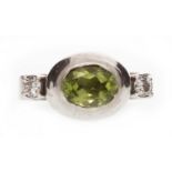 A DIAMOND AND GREEN GEM RING