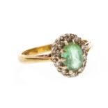 A DIAMOND AND GREEN GEM SET RING