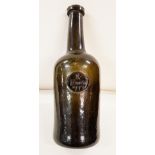 AN EIGHTEENTH CENTURY DARK GREEN GLASS WINE BOTTLE,