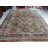 A LARGE ORIENTAL STYLE MACHINE MADE CARPET