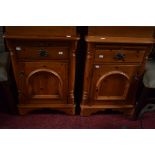 A PAIR OF VICTORIAN STYLE PINE BEDSIDE CUPBOARDS