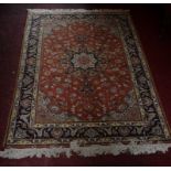 A FINE PART-SILK PERSIAN RUG