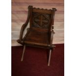 A PAIR OF SEVENTEEN CENTURY STYLE OAK X-FRAMED HALL CHAIRS